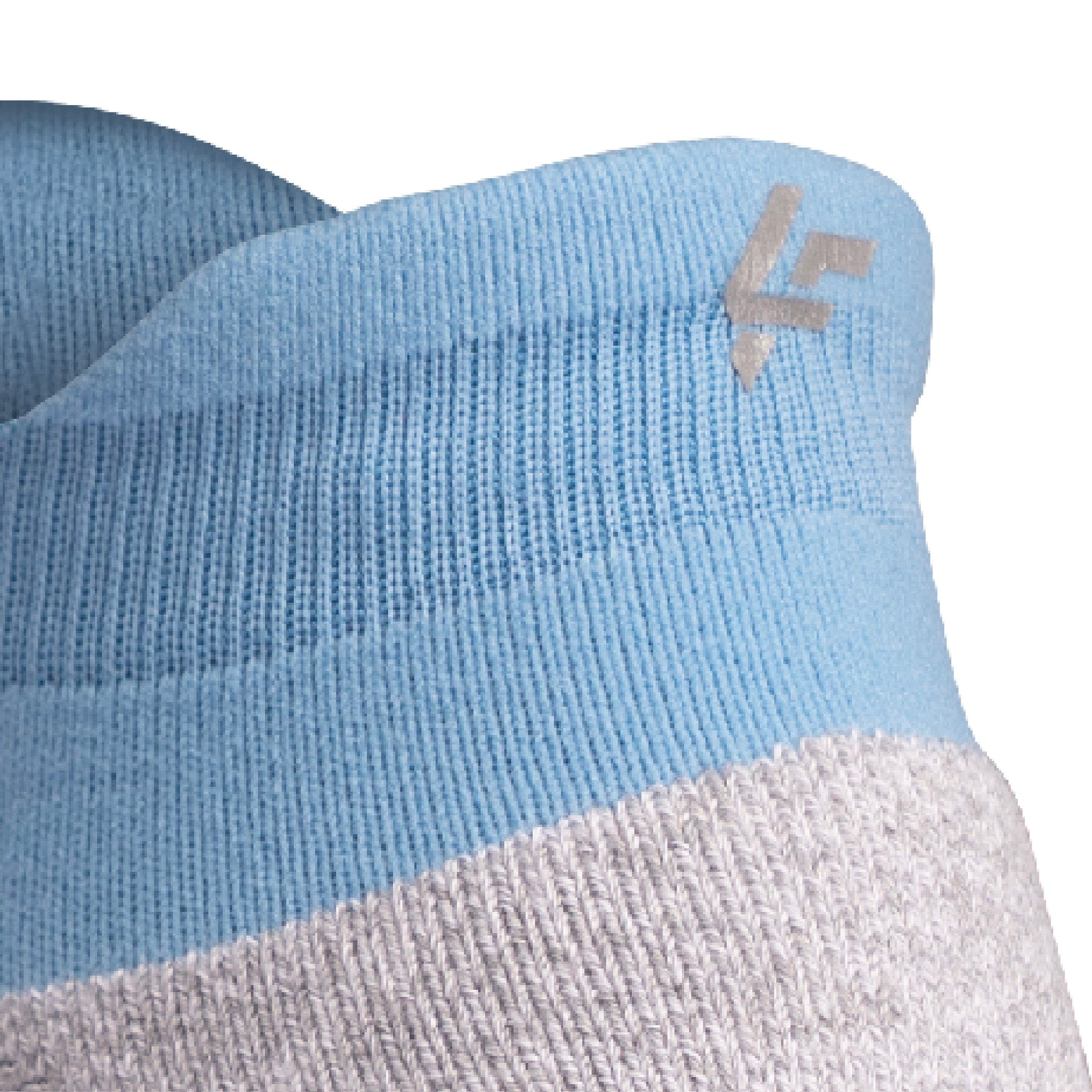 Close up view of reflective symbol on Lightfeet Performance Soft Blue Ankle Sock