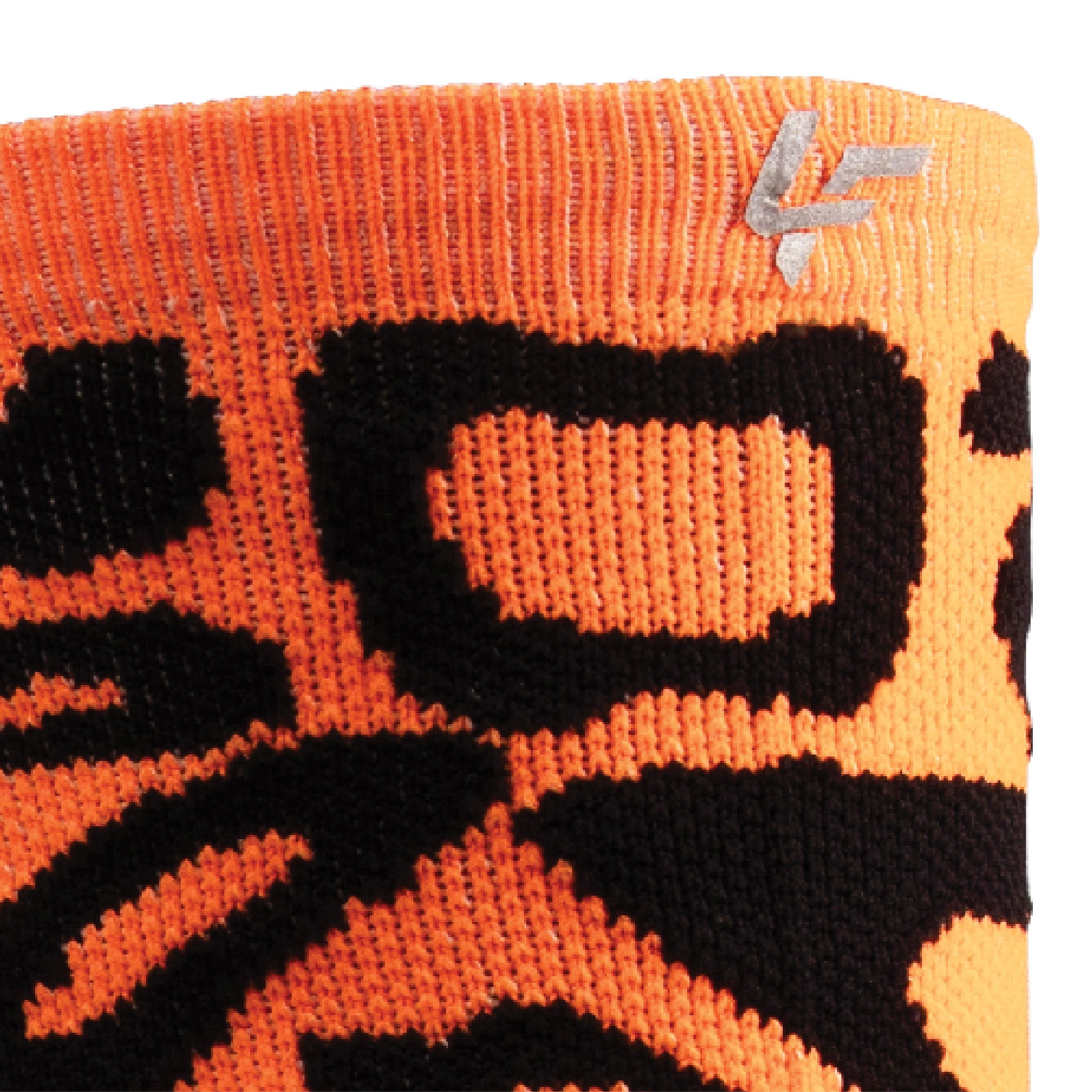 Close up view of reflective print symbol on Lightfeet Performance Scribbles Orange Black Crew Socks