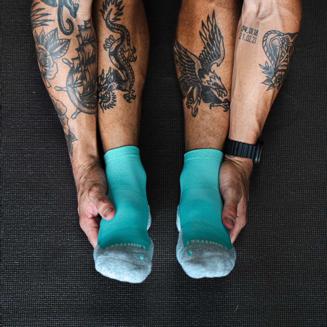 Person wearing Lightfeet Performance Mint Quarter Crew Socks