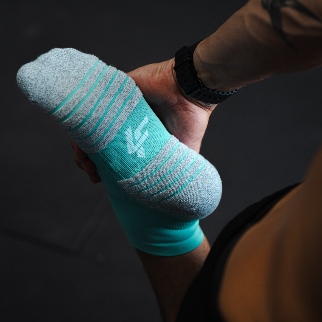 Person wearing Lightfeet Performance Mint Quarter Crew Socks