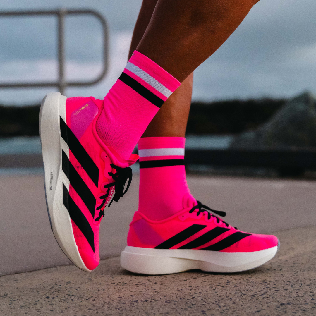 Image of person wearing Lightfeet Performance 2 Stripes Pink White Black_x0010_Crew Socks 
