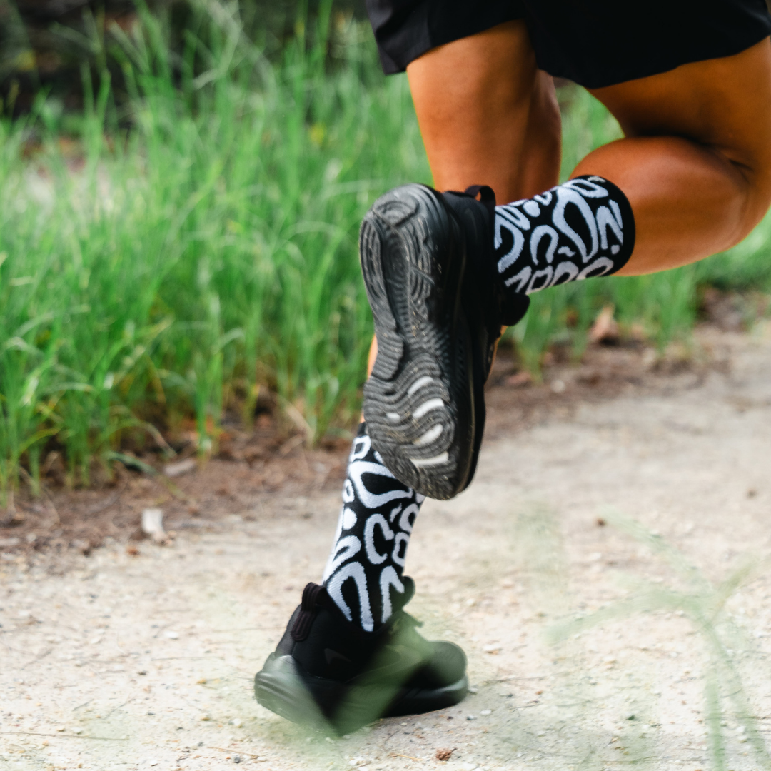 Image of person wearing Lightfeet Performance Scribbles Black White Crew Socks 