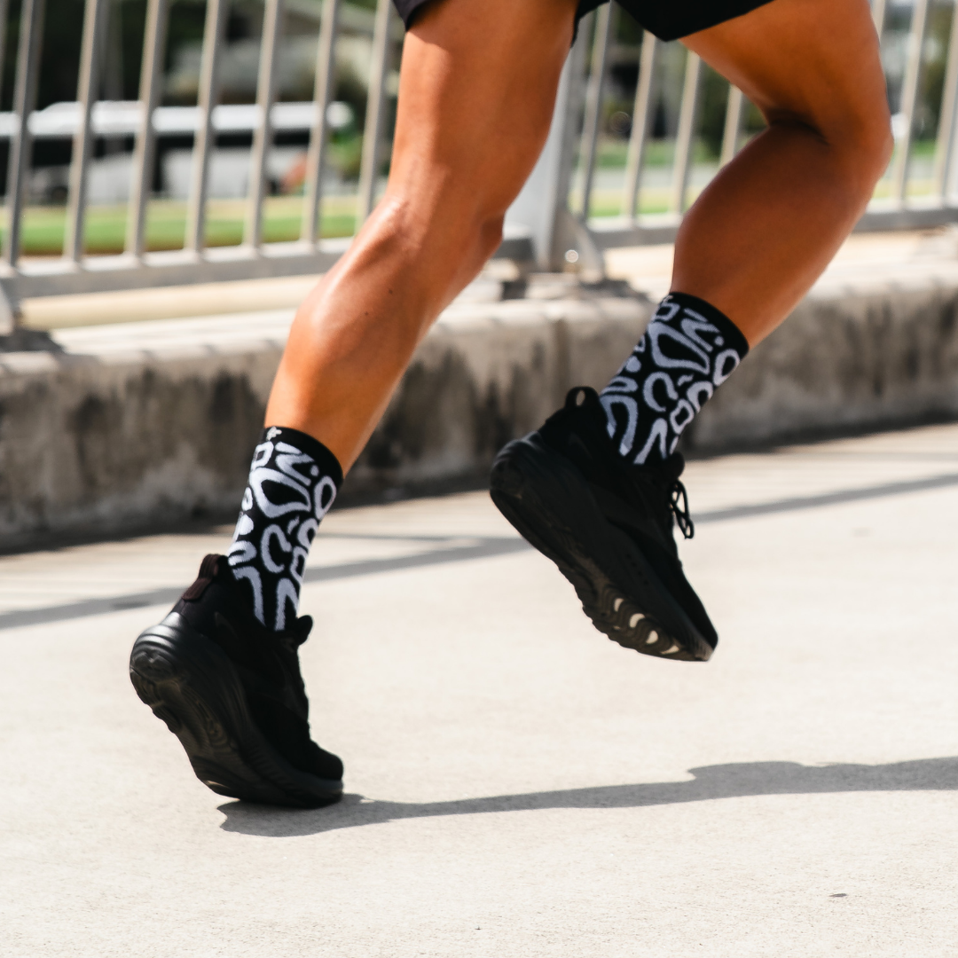 Image of person wearing Lightfeet Performance Scribbles Black White Crew Socks 