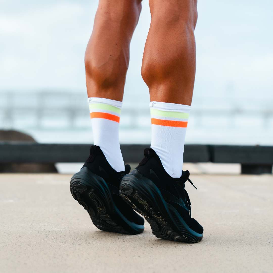 Image of person wearing Lightfeet Performance 2 Stripes White Yellow Orange Crew Socks 