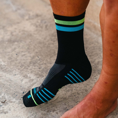 Image of person wearing Lightfeet Performance 2 Stripes Black Yellow Aqua Crew Socks 