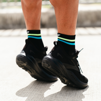 Image of person wearing Lightfeet Performance 2 Stripes Black Yellow Aqua Quarter Socks 