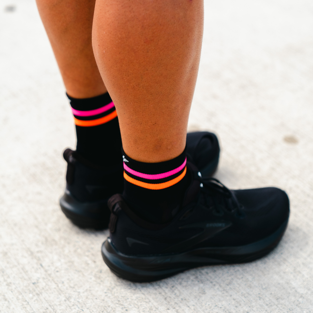 Image of person wearing Lightfeet Performance 2 Stripes Black Pink Orange Quarter Socks 