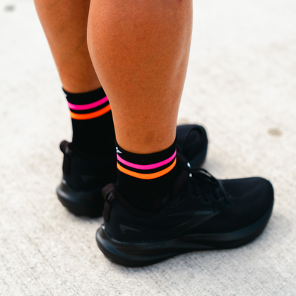 Image of person wearing Lightfeet Performance 2 Stripes Black Pink Orange Quarter Socks 