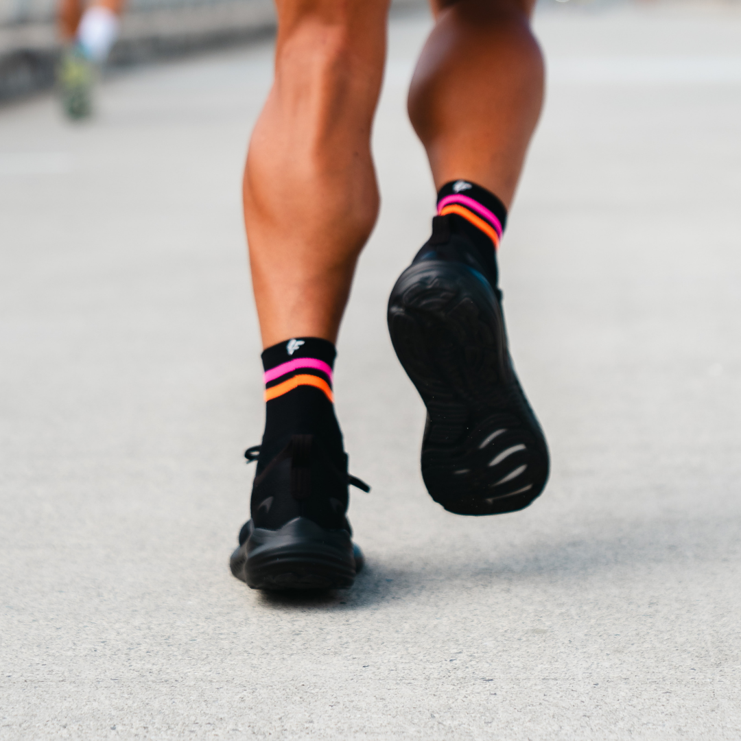 Image of person wearing Lightfeet Performance 2 Stripes Black Pink Orange Quarter Socks 