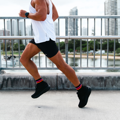 Image of person wearing Lightfeet Performance 2 Stripes Black Pink Orange Quarter Socks 