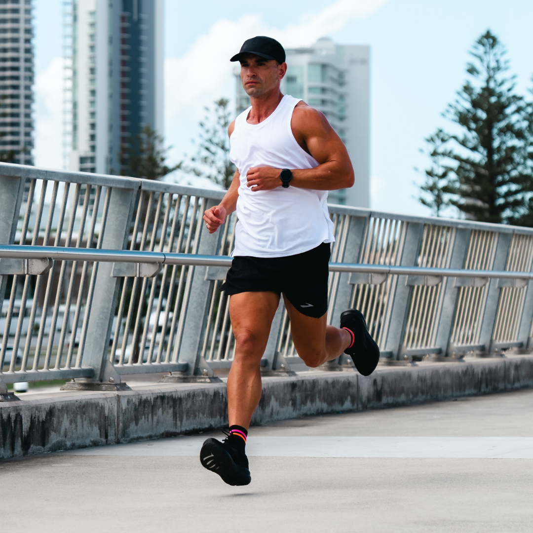 Image of person wearing Lightfeet Performance 2 Stripes Black Pink Orange Quarter Socks 