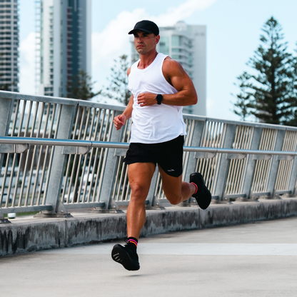 Image of person wearing Lightfeet Performance 2 Stripes Black Pink Orange Quarter Socks 