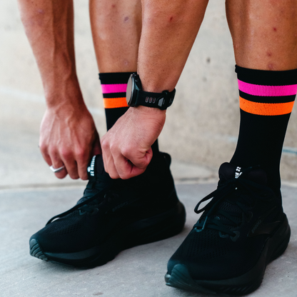 Image of person wearing Lightfeet Performance 2 Stripes Black Pink Orange Quarter Socks 