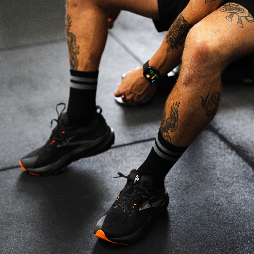 Image of person wearing Lightfeet Performance 2 Stripes Black Half Crew Socks 