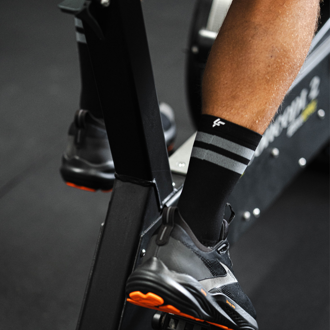 Image of person wearing Lightfeet Performance 2 Stripes Black Half Crew Socks 