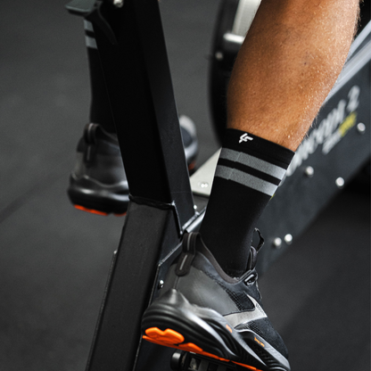 Image of person wearing Lightfeet Performance 2 Stripes Black Half Crew Socks 