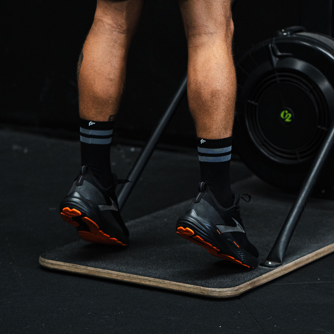 Image of person wearing Lightfeet Performance 2 Stripes Black Half Crew Socks 