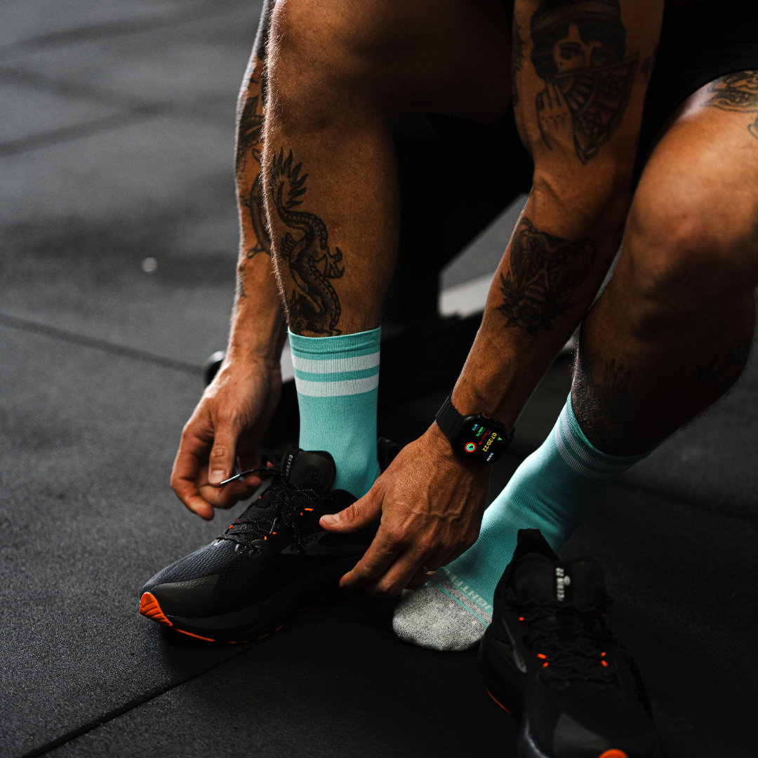Image of person wearing Lightfeet Performance 2 Stripes Mint Half Crew Socks 