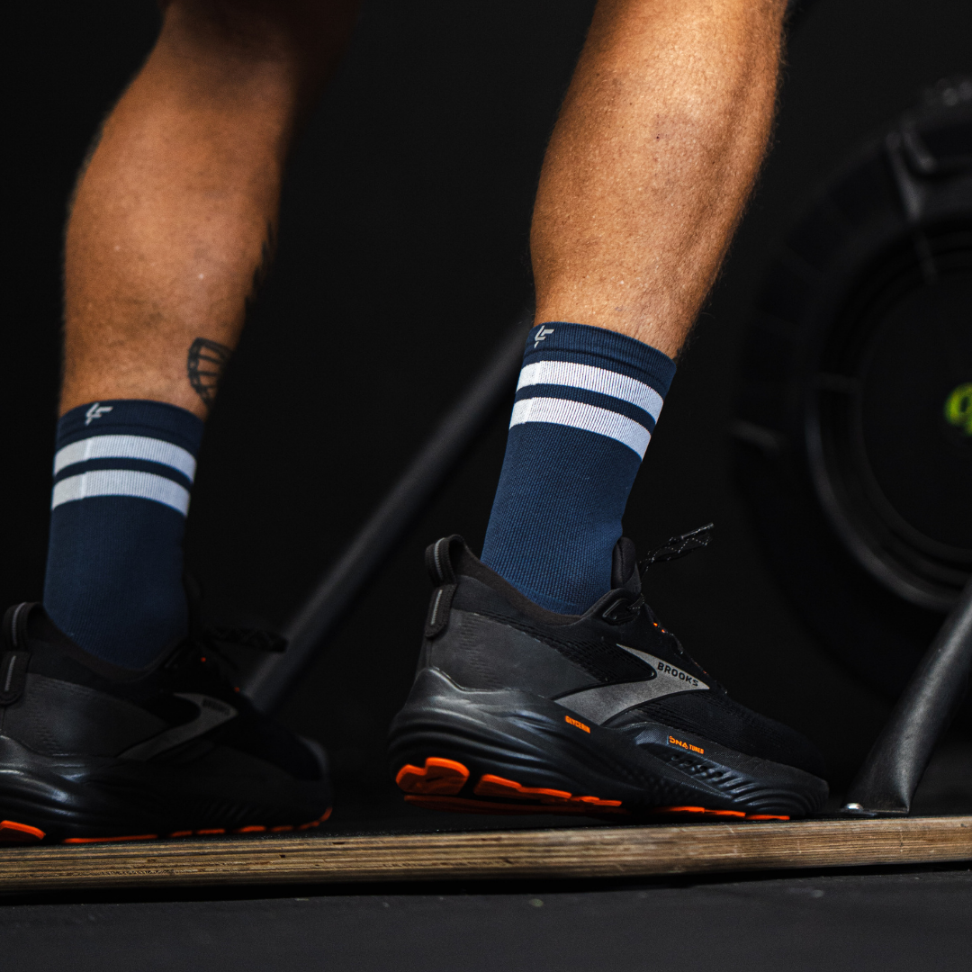 Image of person wearing Lightfeet Performance 2 Stripes Navy Half Crew Socks 