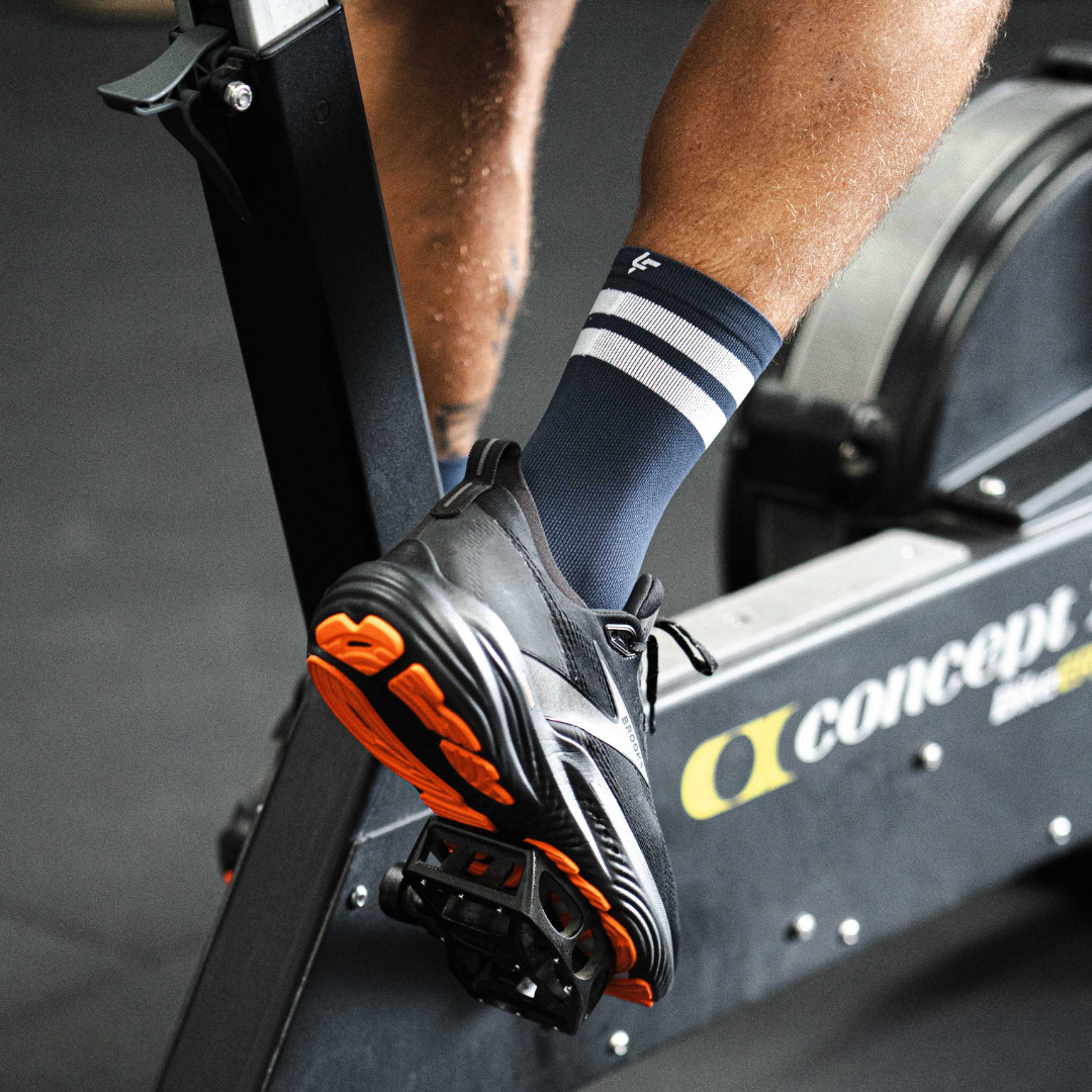 Image of person wearing Lightfeet Performance 2 Stripes Navy Half Crew Socks 