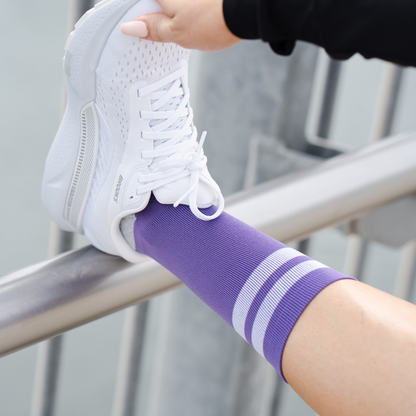 Image of person wearing Lightfeet Performance 2 Stripes Violet Half Crew Socks 