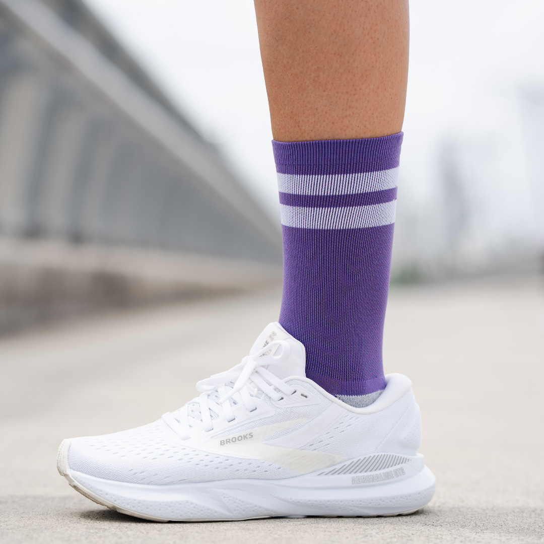 Image of person wearing Lightfeet Performance 2 Stripes Violet Half Crew Socks 