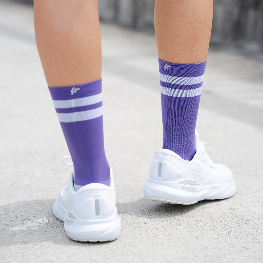Image of person wearing Lightfeet Performance 2 Stripes Violet Half Crew Socks 