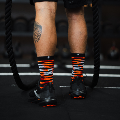 Image of person wearing Lightfeet Performance Predator Black Red Orange Half Crew Socks 