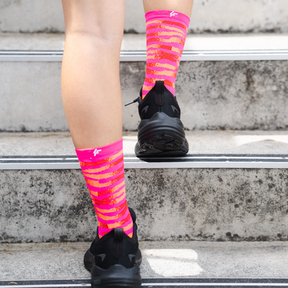 Image of person wearing Lightfeet Performance Predator Pink Red Orange Half Crew Socks 