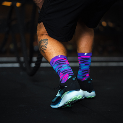 Image of person wearing Lightfeet Performance Predator Purple Aqua Pink Half Crew Socks 