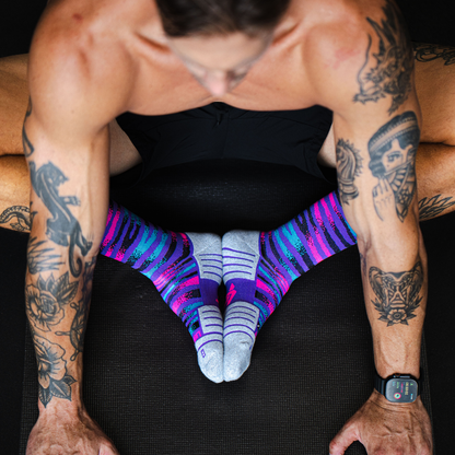 Image of person wearing Lightfeet Performance Predator Purple Aqua Pink Half Crew Socks 