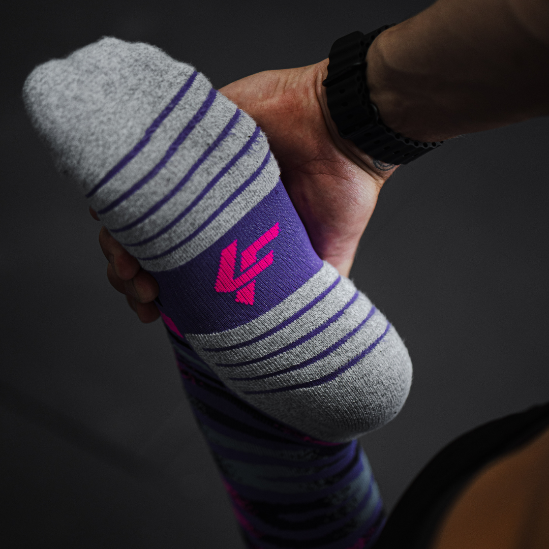 Image of person wearing Lightfeet Performance Predator Purple Aqua Pink Half Crew Socks 