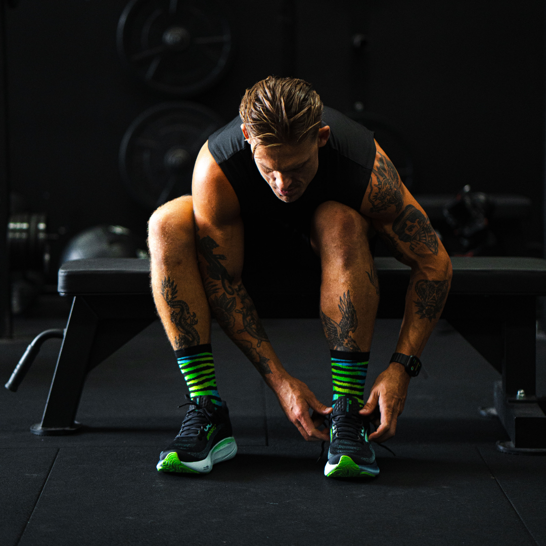 Image of person wearing Lightfeet Performance Predator Black Yellow Aqua Half Crew Sock 