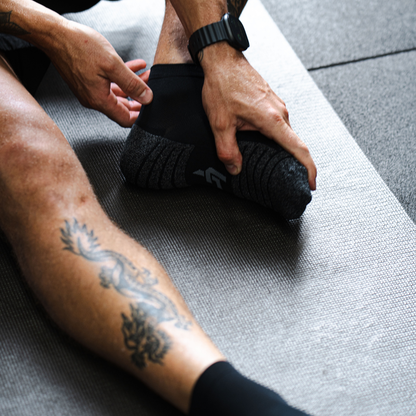 Person wearing Lightfeet Performance Black Quarter Crew Socks 