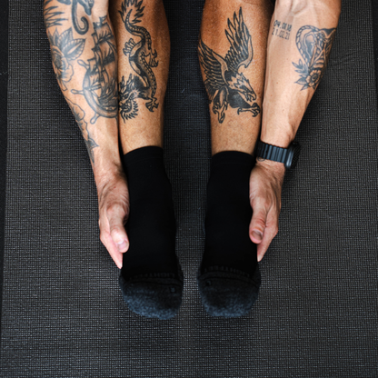 Person wearing Lightfeet Performance Black Quarter Crew Socks 