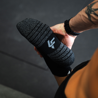 Person wearing Lightfeet Performance Black Quarter Crew Socks 