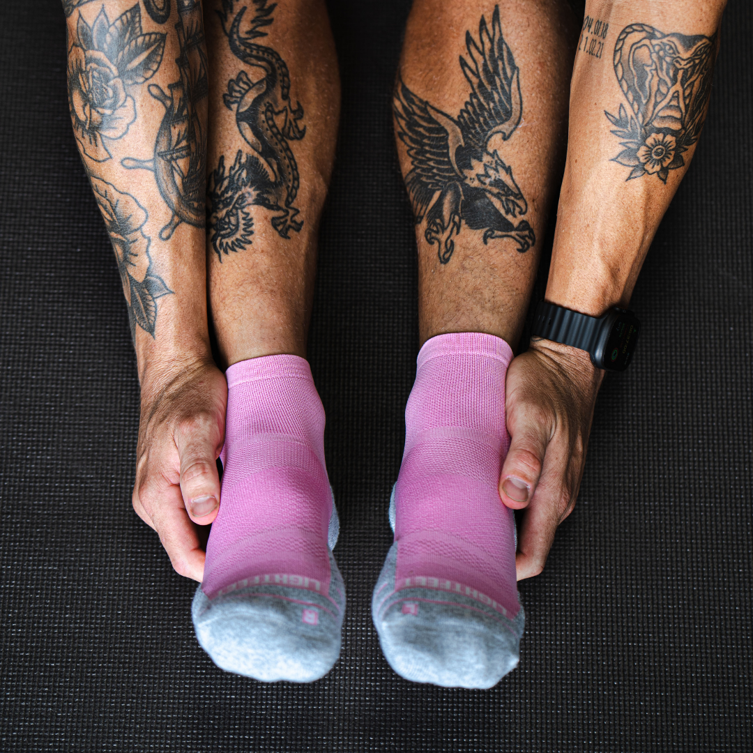 Person wearing Lightfeet Performance Soft Pink Quarter Crew Socks 