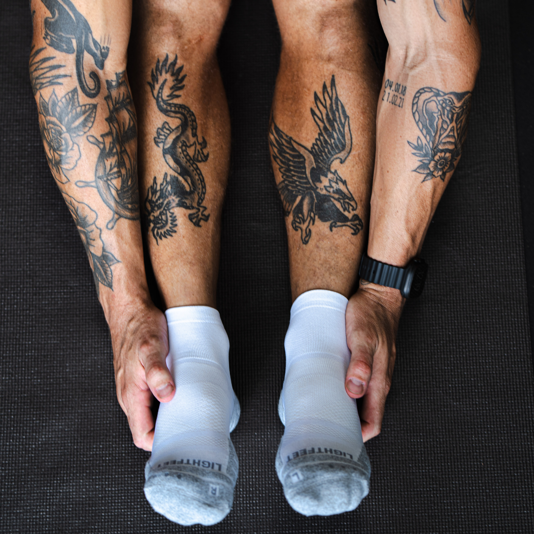 Person wearing Lightfeet Performance White Quarter Crew Socks 