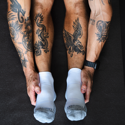 Person wearing Lightfeet Performance White Quarter Crew Socks 